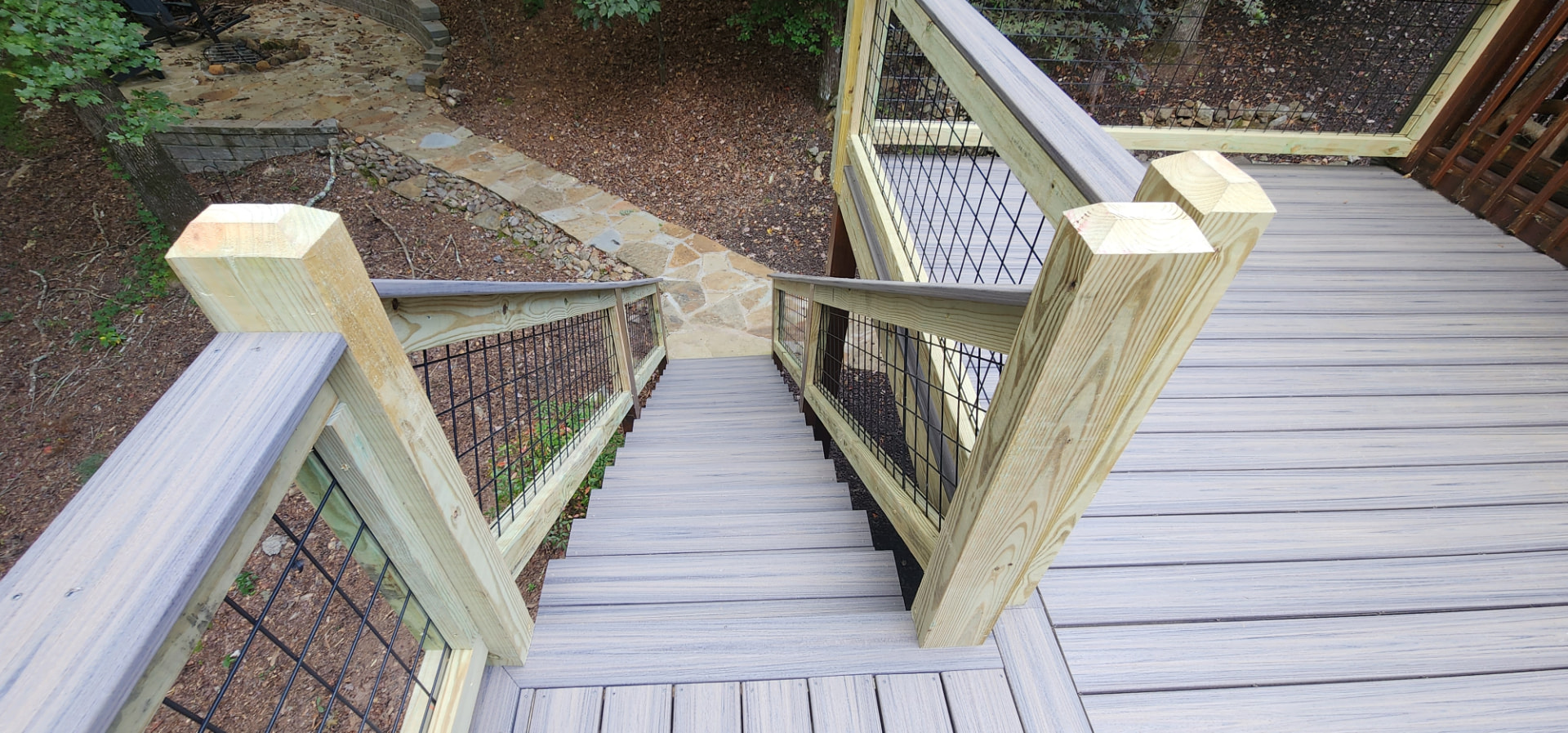 Composite deck stairs down to a flagstone walkway