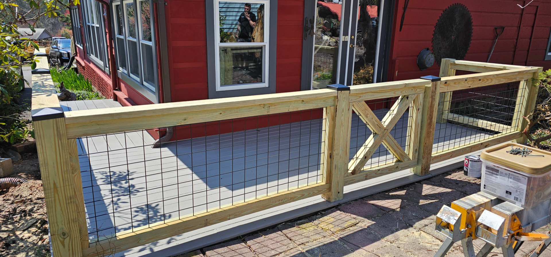 Custom wood and wire deck railing with X-brace detail
